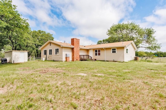 1941 State Highway 59 S, Bowie, TX 76230 - rear view of house featuring a storage unit, an outdoor structure, a chimney, a wooden deck, and central air condition unit