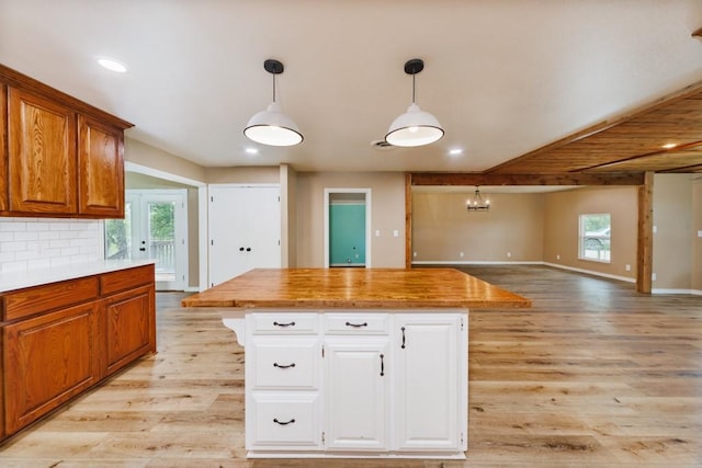 1941 State Highway 59 S, Bowie, TX 76230 - kitchen featuring light wood-style floors, white cabinetry, open floor plan, pendant lighting, and recessed lighting