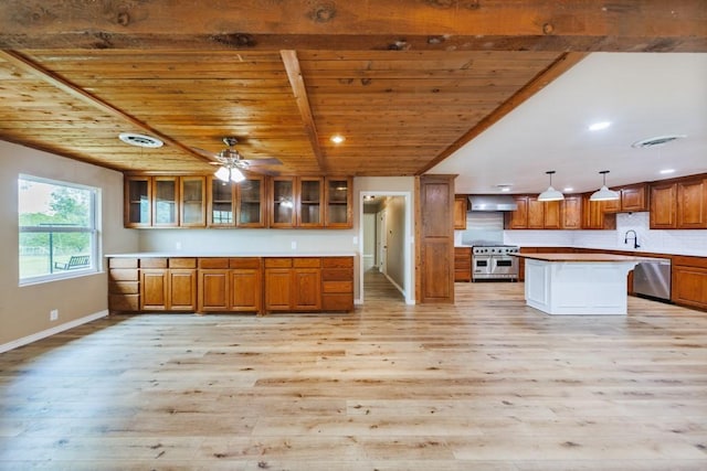 1941 State Highway 59 S, Bowie, TX 76230 - kitchen featuring stainless steel appliances, wall chimney range hood, wooden ceiling, light wood-type flooring, and brown cabinets
