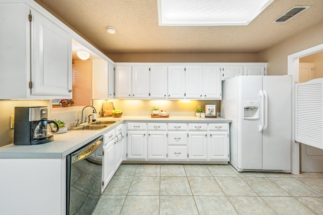 kitchen with white refrigerator with ice dispenser, a sink, dishwasher, white cabinetry, and a textured ceiling
