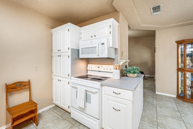 kitchen featuring white appliances, light tile patterned floors, baseboards, white cabinetry, and a textured ceiling