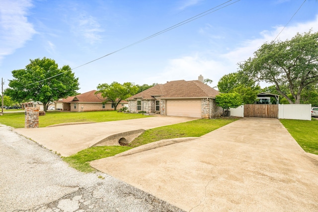 view of front of property featuring driveway, an attached garage, and a chimney