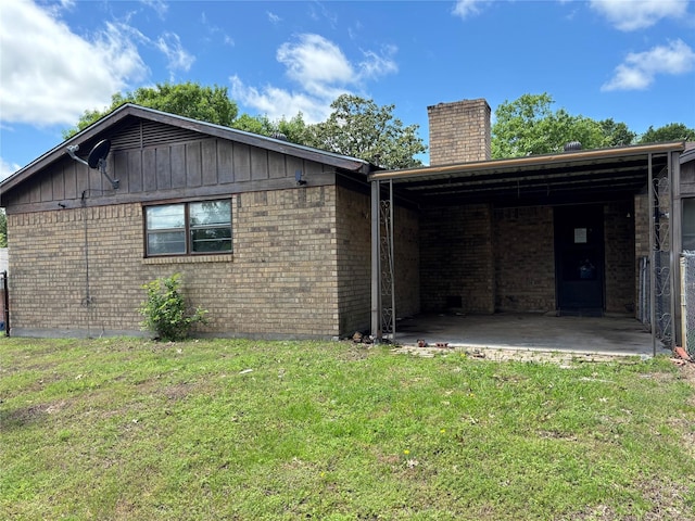 3122 Frances Dr, Denison, TX 75020 - view of property exterior featuring a chimney, a yard, brick siding, a patio area, and board and batten siding