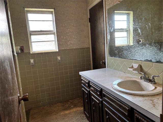 3122 Frances Dr, Denison, TX 75020 - bathroom with tile walls, wainscoting, wallpapered walls, and vanity
