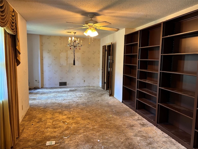 3122 Frances Dr, Denison, TX 75020 - unfurnished room with a textured ceiling, a chandelier, wallpapered walls, and a ceiling fan
