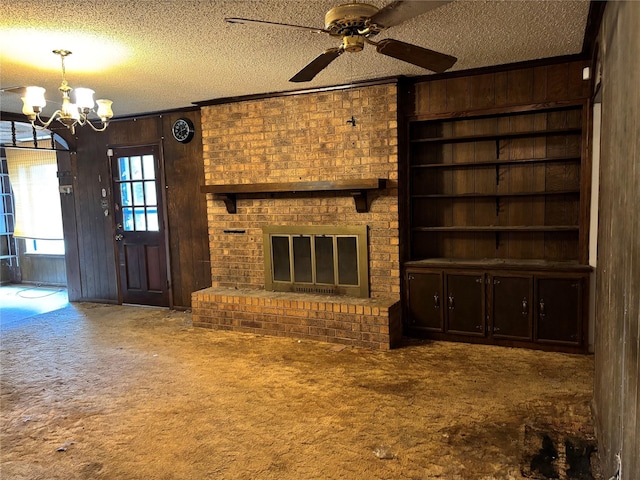 3122 Frances Dr, Denison, TX 75020 - unfurnished living room featuring a textured ceiling, carpet floors, wooden walls, a chandelier, and ceiling fan