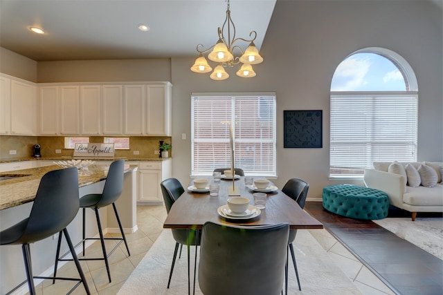 dining room with light tile patterned floors, a chandelier, and recessed lighting