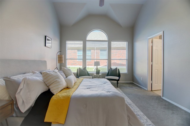 carpeted bedroom featuring lofted ceiling, baseboards, and a ceiling fan