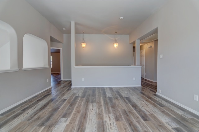 empty room with wood finished floors and baseboards