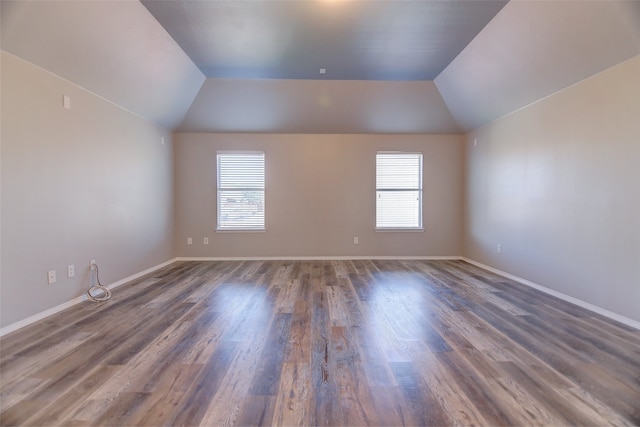bonus room with wood finished floors, vaulted ceiling, and baseboards