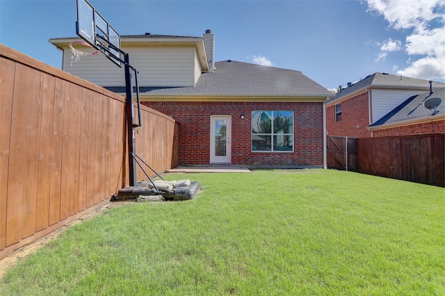 back of property featuring brick siding, a chimney, and a shingled roof