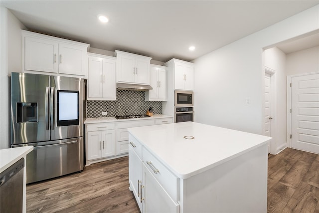 2507 Henley Way, Mansfield, TX 76084 - kitchen featuring appliances with stainless steel finishes, tasteful backsplash, white cabinets, light countertops, and dark wood finished floors