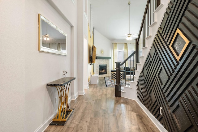 2507 Henley Way, Mansfield, TX 76084 - entryway with a ceiling fan, stairs, a stone fireplace, wood finished floors, and baseboards