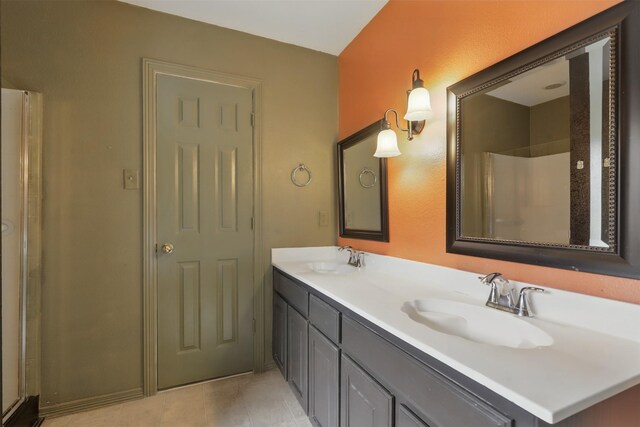 bathroom with double vanity and a shower