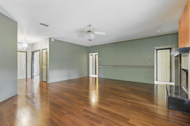 unfurnished living room with wood finished floors, a fireplace, and a ceiling fan