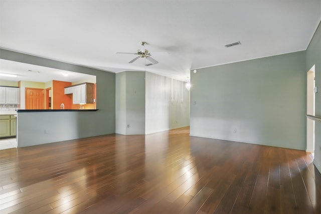 unfurnished living room with ceiling fan and wood finished floors