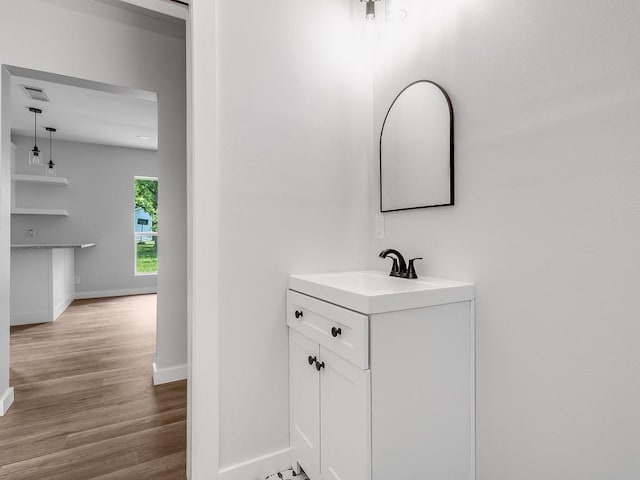 610 SW 3rd St, Kerens, TX 75144 - bathroom featuring baseboards, wood finished floors, and vanity