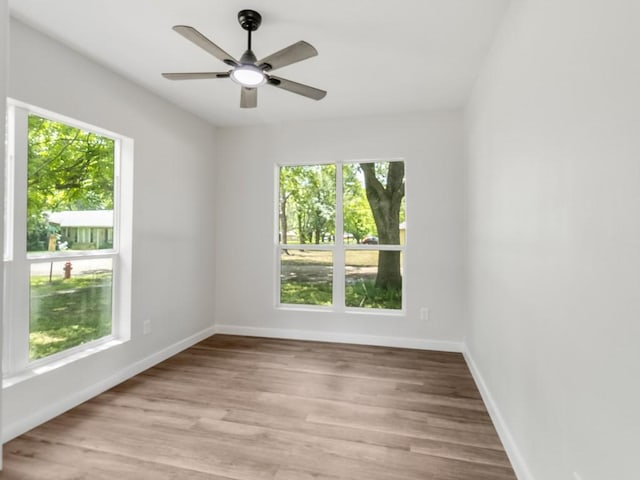610 SW 3rd St, Kerens, TX 75144 - empty room with healthy amount of natural light, light wood finished floors, and baseboards