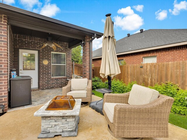 view of patio with a fire pit, a ceiling fan, fence, and central air condition unit