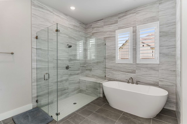 175 Stirling Dr, Argyle, TX 76226 - bathroom featuring a stall shower, a freestanding bath, tile patterned floors, and tile walls