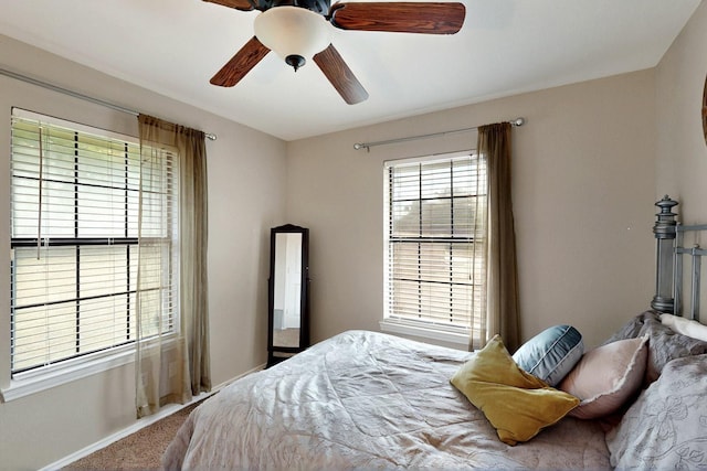 bedroom featuring carpet, baseboards, and a ceiling fan