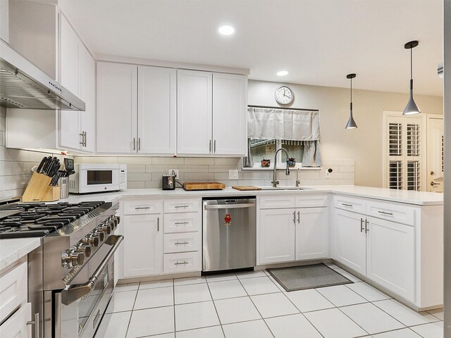 2626 Rivercrest Dr, Arlington, TX 76006 - kitchen featuring stainless steel appliances, wall chimney exhaust hood, a sink, backsplash, and recessed lighting