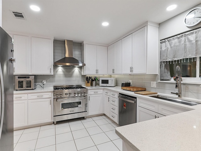 2626 Rivercrest Dr, Arlington, TX 76006 - kitchen with wall chimney range hood, stainless steel appliances, a sink, tasteful backsplash, and recessed lighting