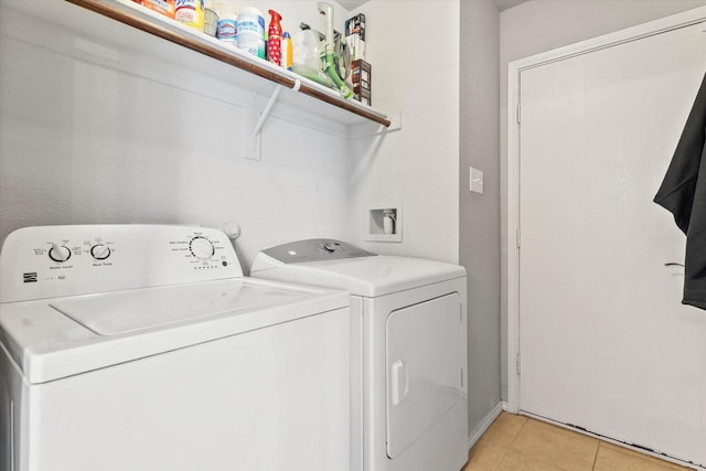 240 Willow Creek Ln, Terrell, TX 75160 - laundry room featuring washing machine and dryer and light tile patterned floors