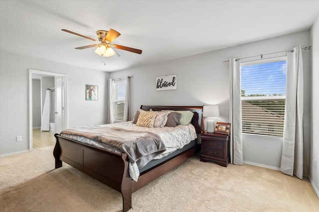 240 Willow Creek Ln, Terrell, TX 75160 - bedroom with light colored carpet, baseboards, a ceiling fan, and ensuite bathroom