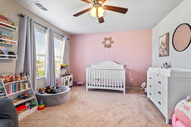 240 Willow Creek Ln, Terrell, TX 75160 - bedroom with carpet flooring, a crib, and ceiling fan