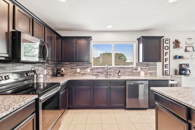240 Willow Creek Ln, Terrell, TX 75160 - kitchen featuring electric range, a sink, tasteful backsplash, light stone countertops, and recessed lighting