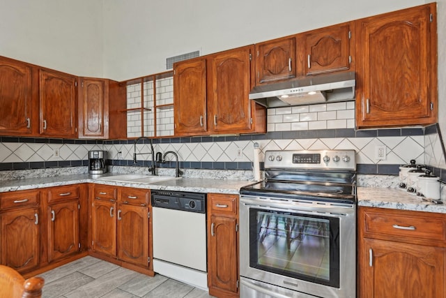 7600 Independence Dr, The Colony, TX 75056 - kitchen with stainless steel electric range oven, white dishwasher, under cabinet range hood, a sink, and tasteful backsplash