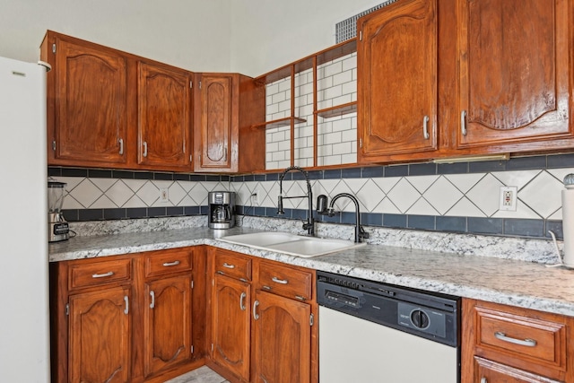 7600 Independence Dr, The Colony, TX 75056 - kitchen featuring white appliances, a sink, decorative backsplash, and brown cabinets