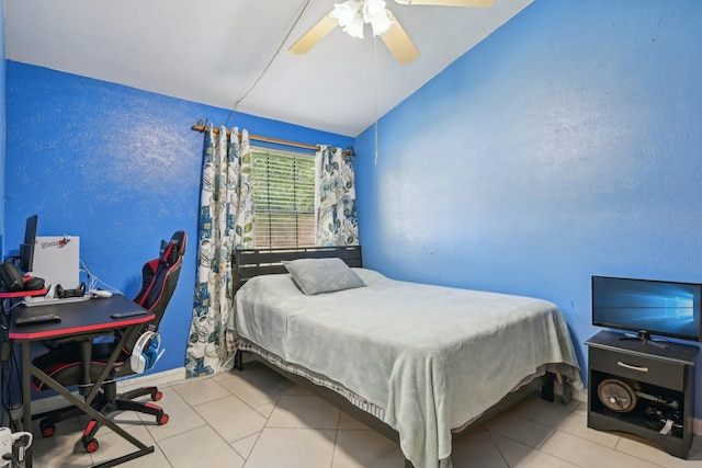 7600 Independence Dr, The Colony, TX 75056 - bedroom featuring vaulted ceiling, tile patterned floors, ceiling fan, a textured wall, and baseboards