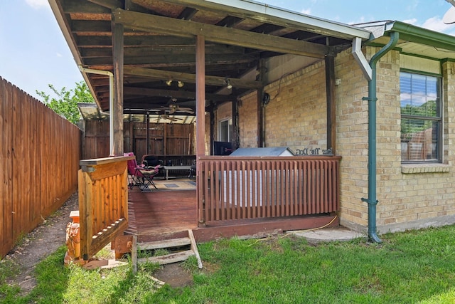 7600 Independence Dr, The Colony, TX 75056 - view of property exterior featuring ceiling fan, a fenced backyard, a deck, and brick siding