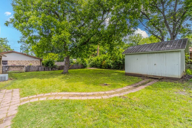 view of yard with a storage shed and an outbuilding