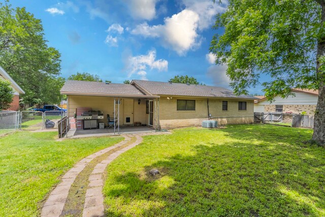 rear view of house featuring a patio, cooling unit, brick siding, and a gate