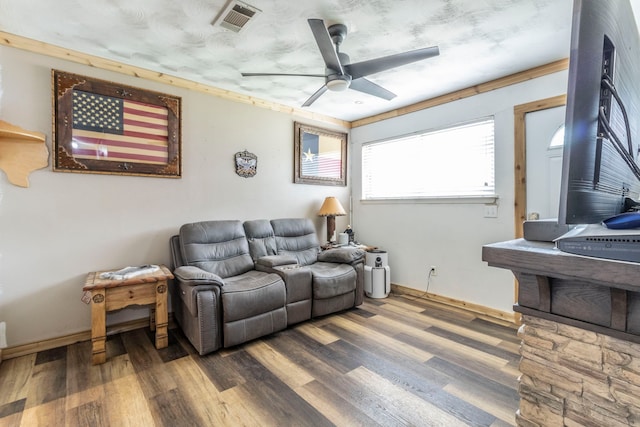 living area with wood finished floors, ceiling fan, and baseboards
