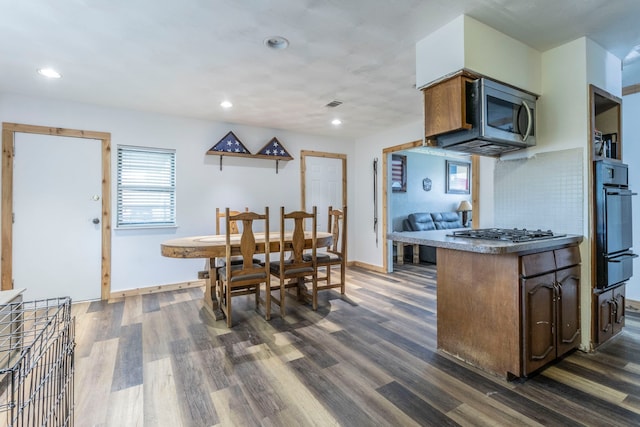kitchen with appliances with stainless steel finishes, dark wood-style floors, baseboards, and recessed lighting