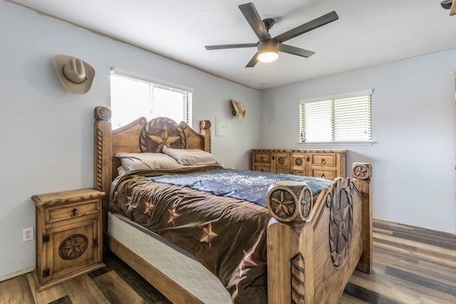 bedroom featuring multiple windows, dark wood-style flooring, and ceiling fan