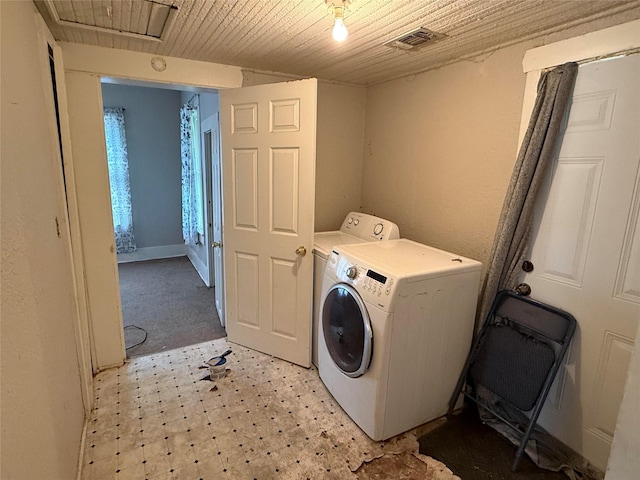 washroom featuring washer / clothes dryer, wood ceiling, and light flooring