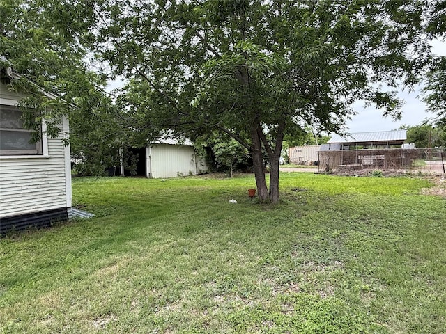 view of yard featuring an outbuilding and a shed