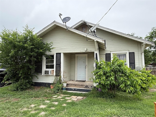 view of front of home with a front lawn and cooling unit