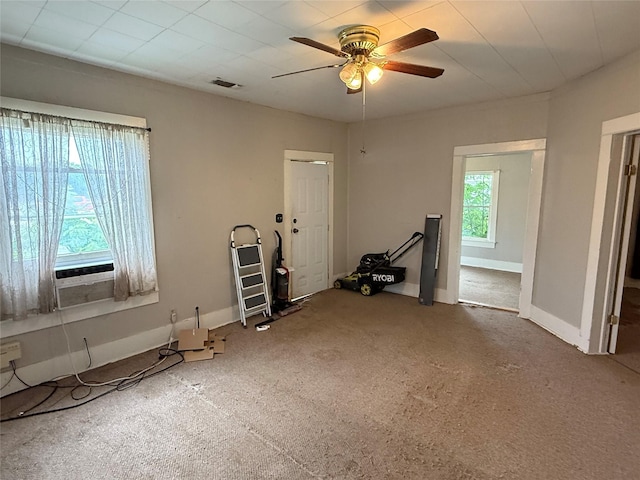 workout area with a ceiling fan, carpet, baseboards, and cooling unit