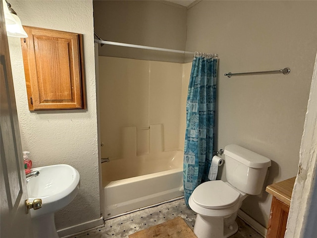 bathroom featuring toilet, shower / bathtub combination with curtain, and a sink