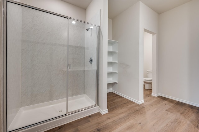 13156 Sanctuary Dr, Providence Village, TX 76227 - full bathroom featuring wood finished floors, a stall shower, toilet, and baseboards