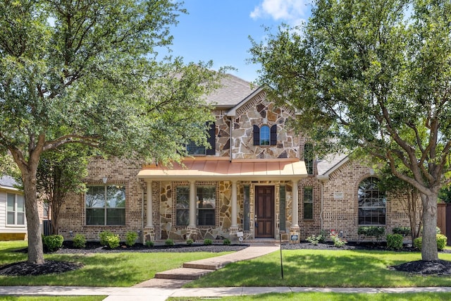 3455 Crosshaven Ln, Frisco, TX 75033 - view of front of property featuring a front yard, stone siding, brick siding, and covered porch