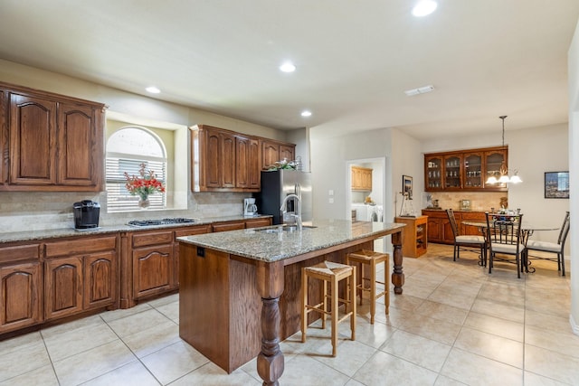 3455 Crosshaven Ln, Frisco, TX 75033 - kitchen with independent washer and dryer, a sink, gas stovetop, backsplash, and stainless steel fridge with ice dispenser