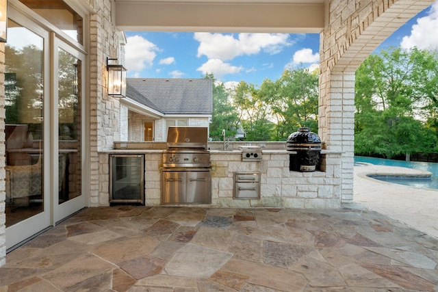 1020 Canyon Trl, Waco, TX 76657 - view of patio with an outdoor kitchen, beverage cooler, a grill, an outdoor pool, and a sink