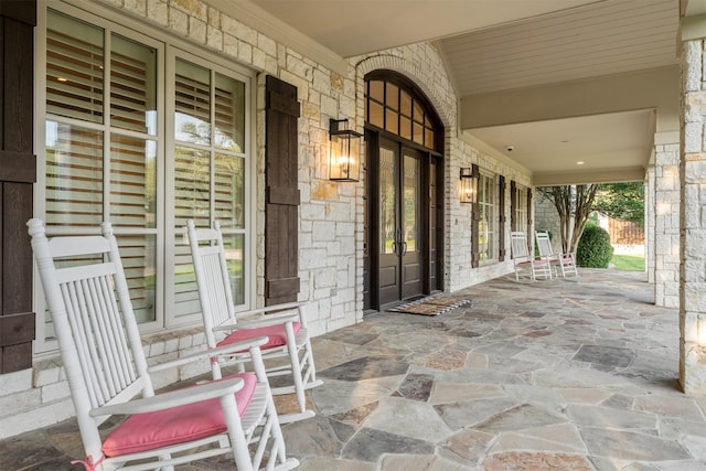 1020 Canyon Trl, Waco, TX 76657 - view of front facade featuring covered porch, french doors, stone siding, and a front yard